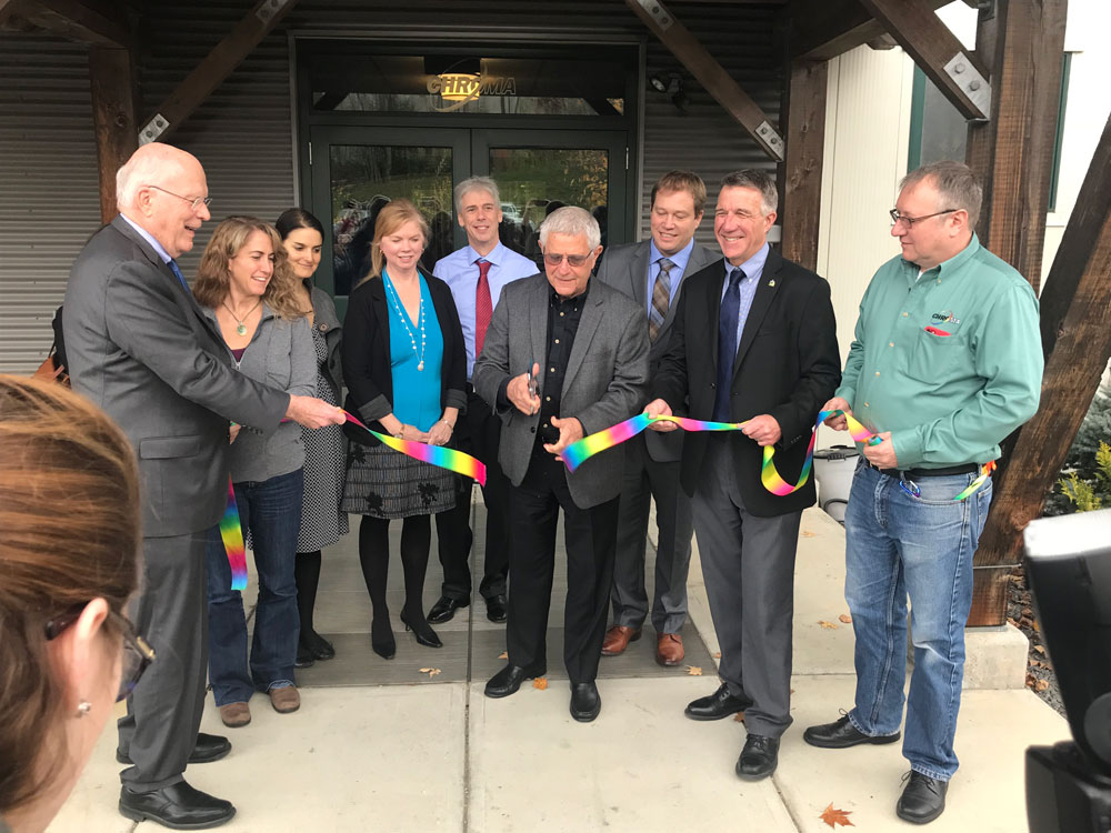 Senator Patrick Leahy, Governor Phil Scott Hold The Ribbon While Paul Millman, President Of Employee-owned Chroma Technology Corp, Cuts The Ribbon As BDCC's Bobbi Kilburn And Adam Grinold Look On.