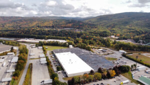 Aerial photo of large industrial building with mountains in the background