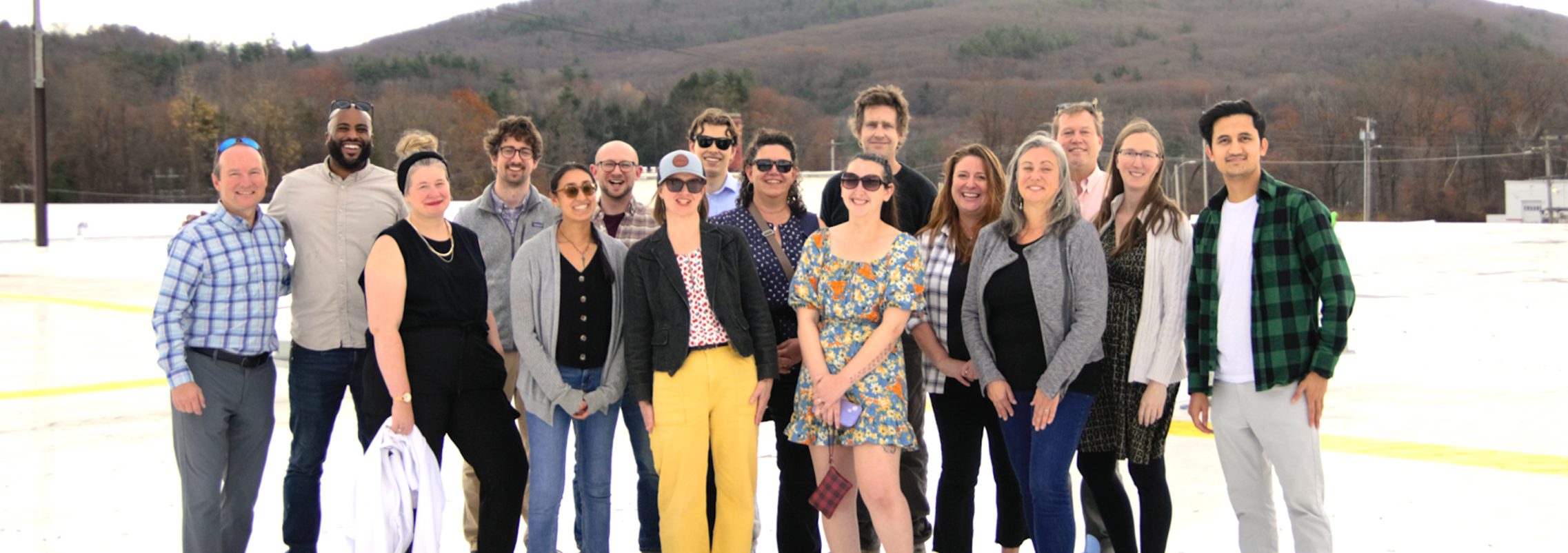 a group of people standing on a commercial rooftop smiling