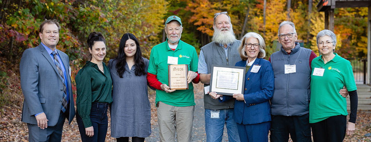 a group of smiling people who recently won an award