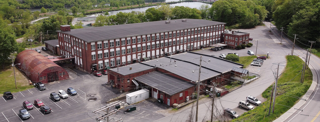 A bird's eye view of a brick mill building complex