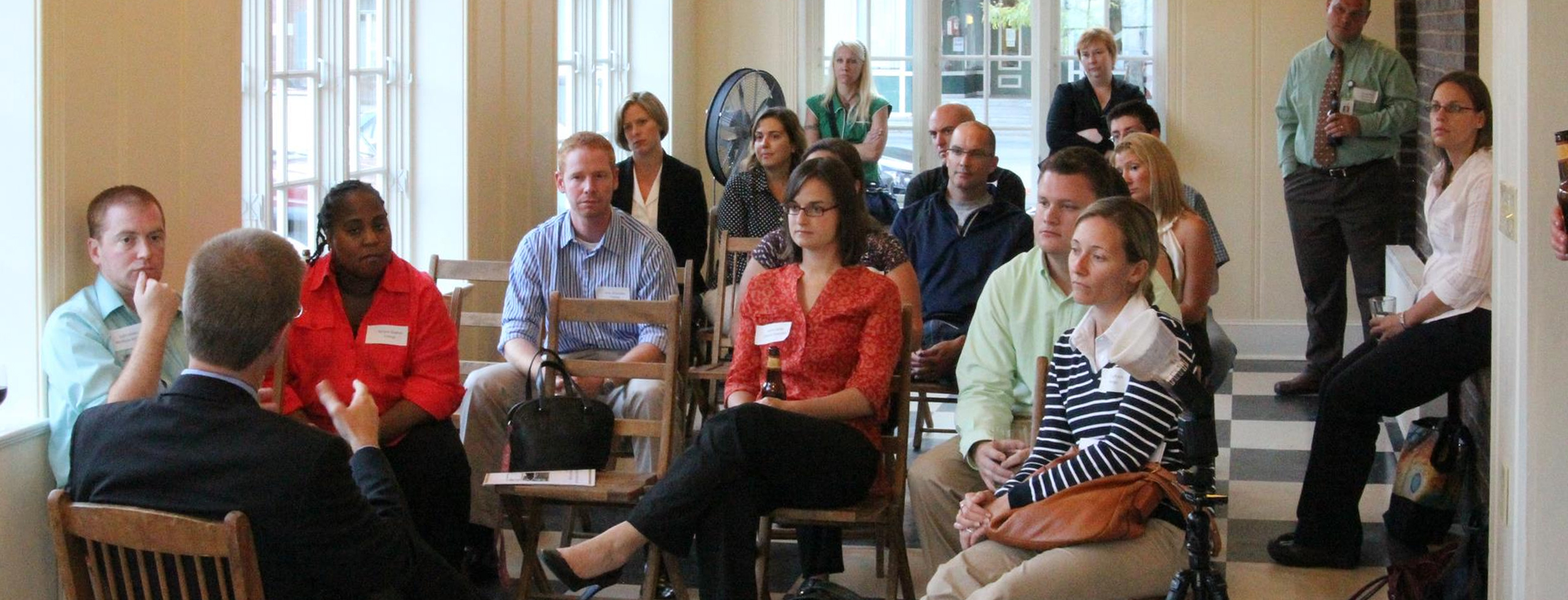 A group of seated people watching a speaker