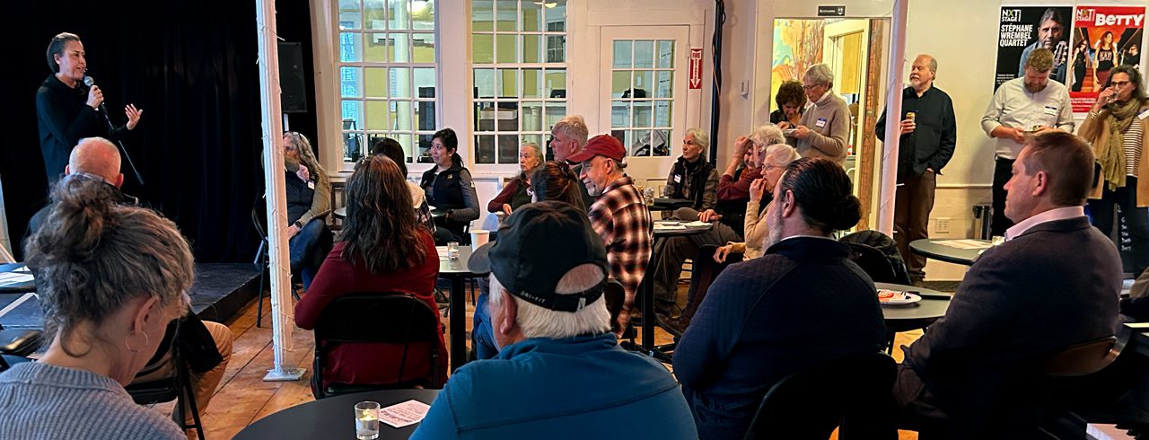 a group of people watching a presenter