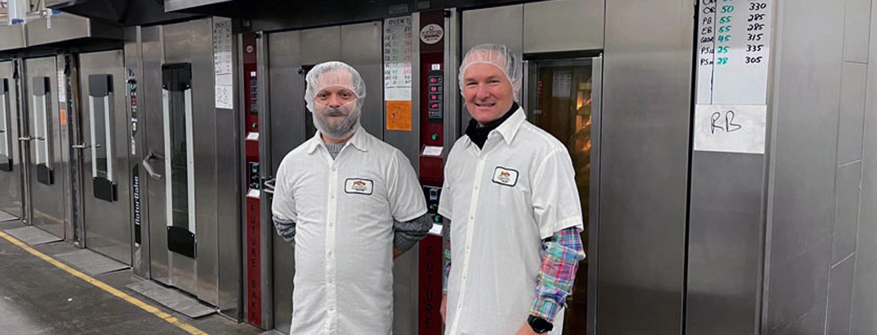 two men in white shirts and hairnets