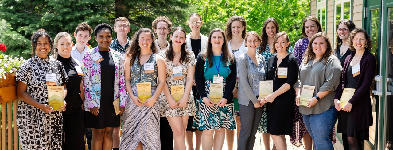 A group of people smiling and holding awards