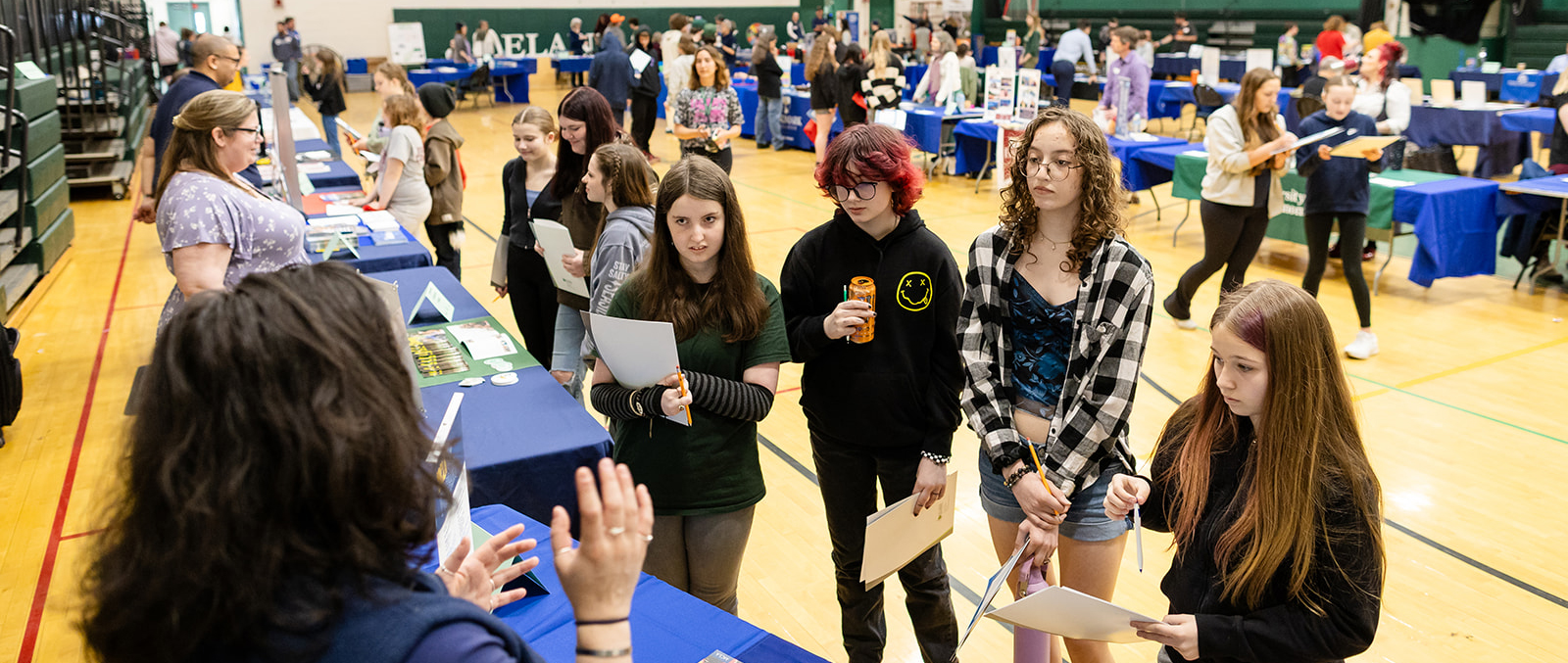 a group of teenagers at a career fair