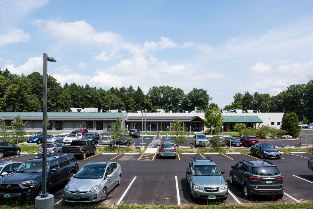 a view of an office building and parking lot