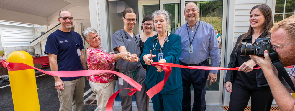 a group of people at a ribbon cutting