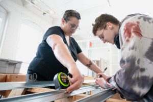 Women measuring wood